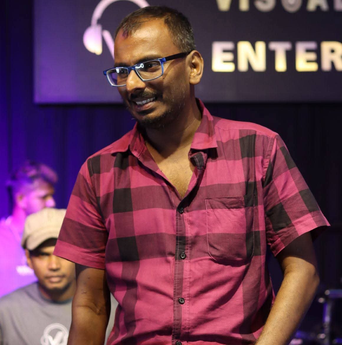 Amila Indika Weligepola smiling on stage
